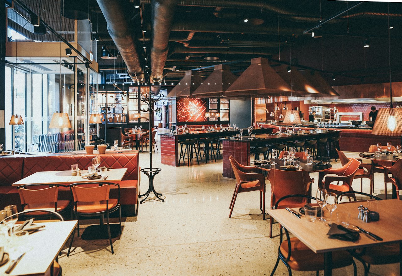 The dining room of a restaurant, tables laid and ready for service